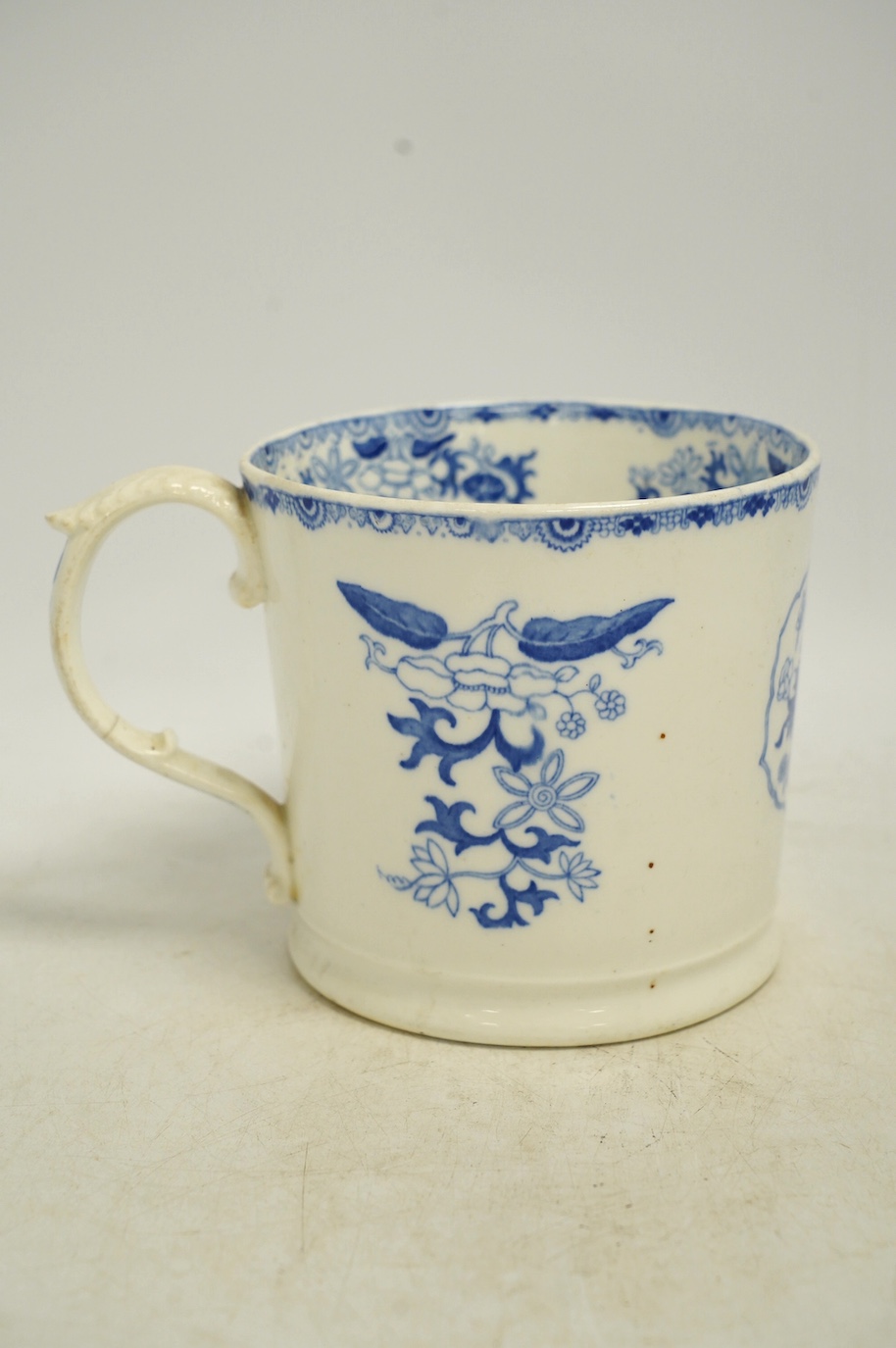 An early Victorian blue and white bone china mug, 13cm high. Condition - fair, crack to the handle